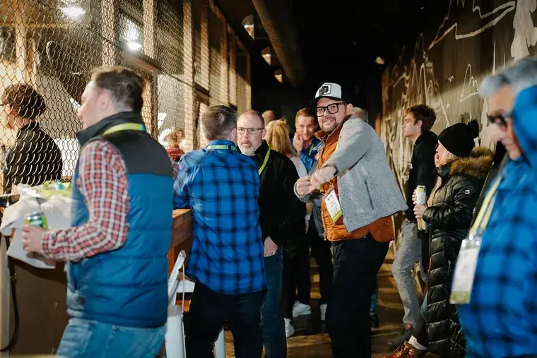 Group mingling with drinks at a Pacific Axes private event
